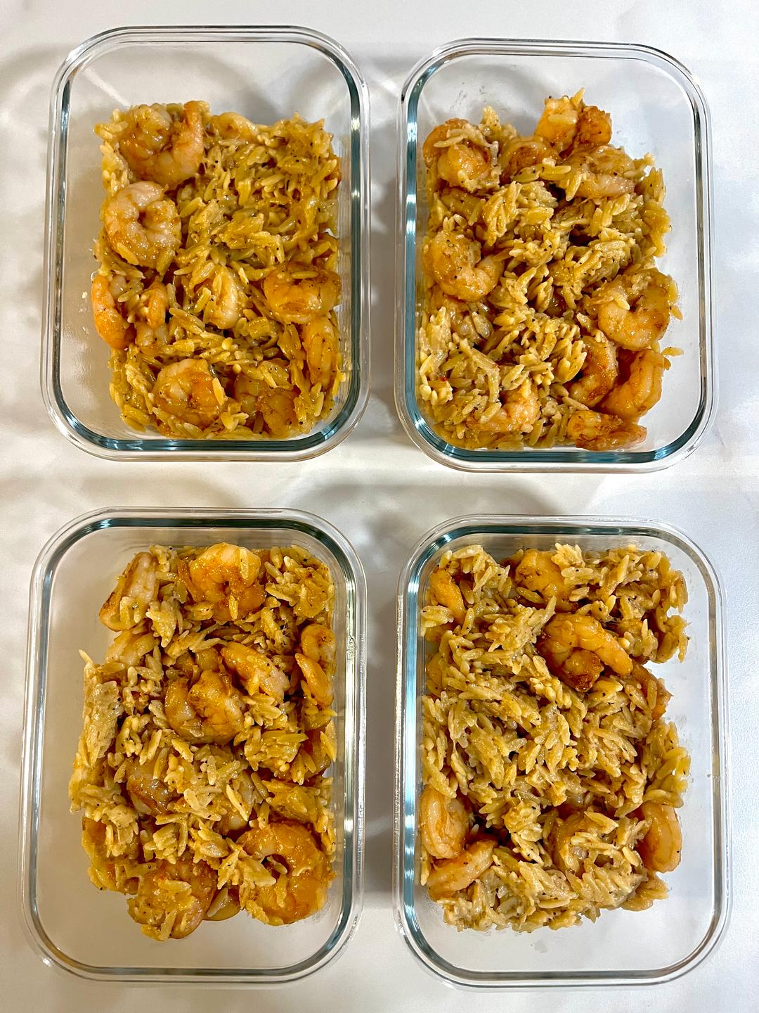 Four prepared servings of Garlic Parmesan Shrimp Orzo