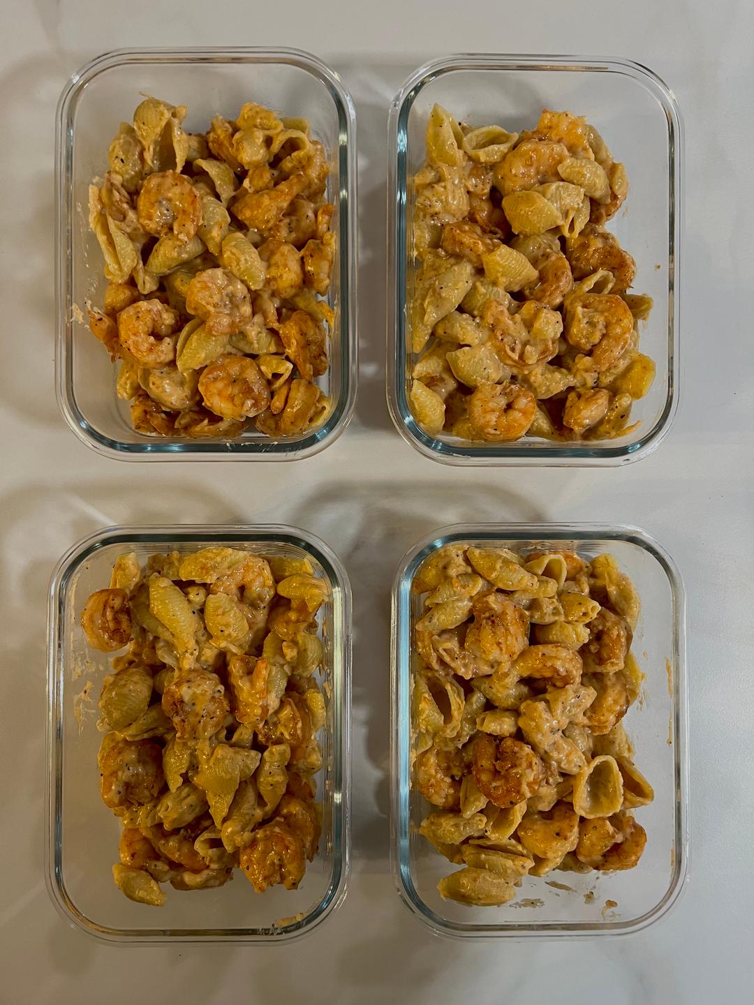 Four prepared servings of Garlic Butter Shrimp Mac & Cheese
