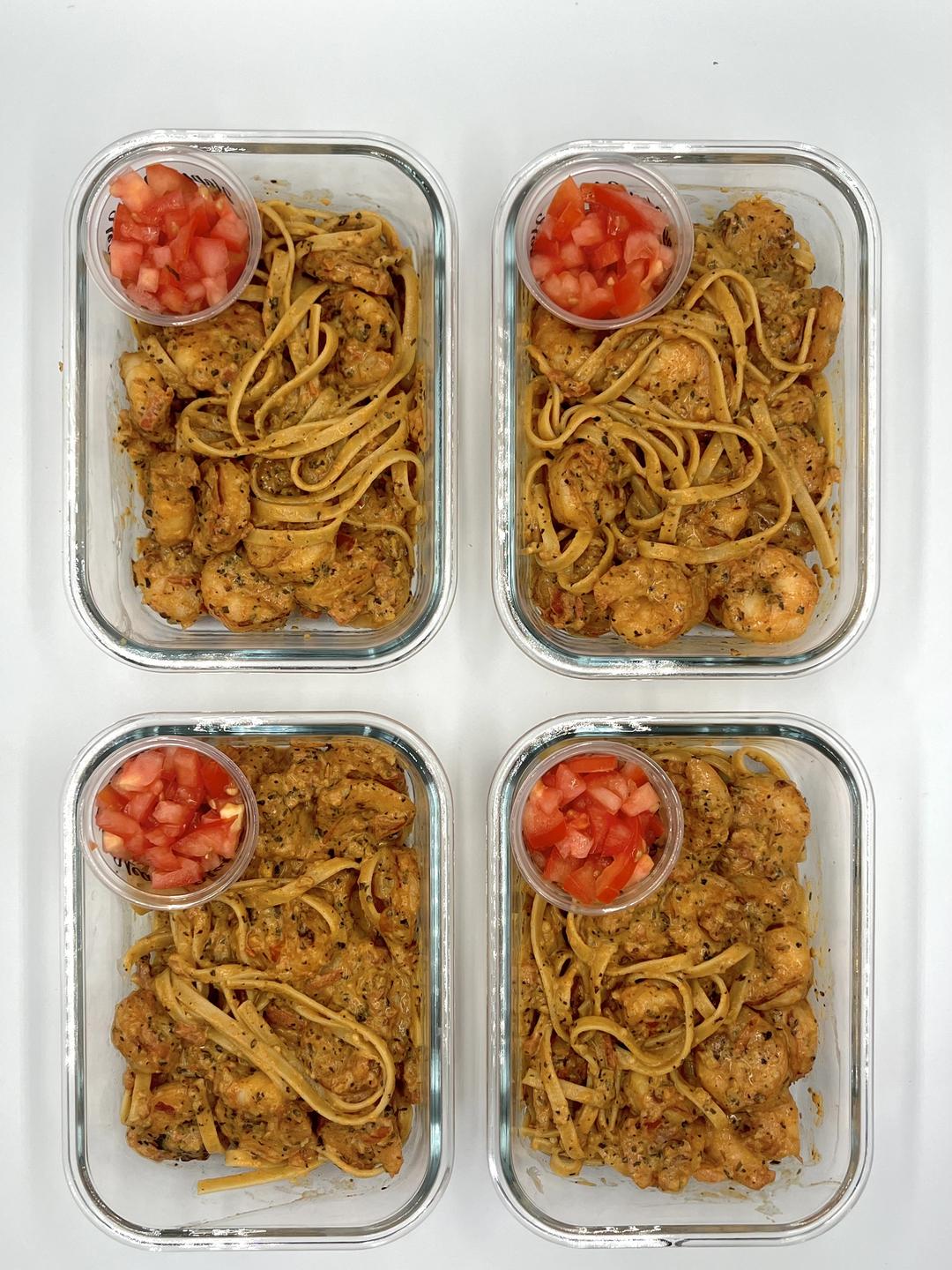 Four prepared servings of Garlic Tomato Shrimp Fettuccini
