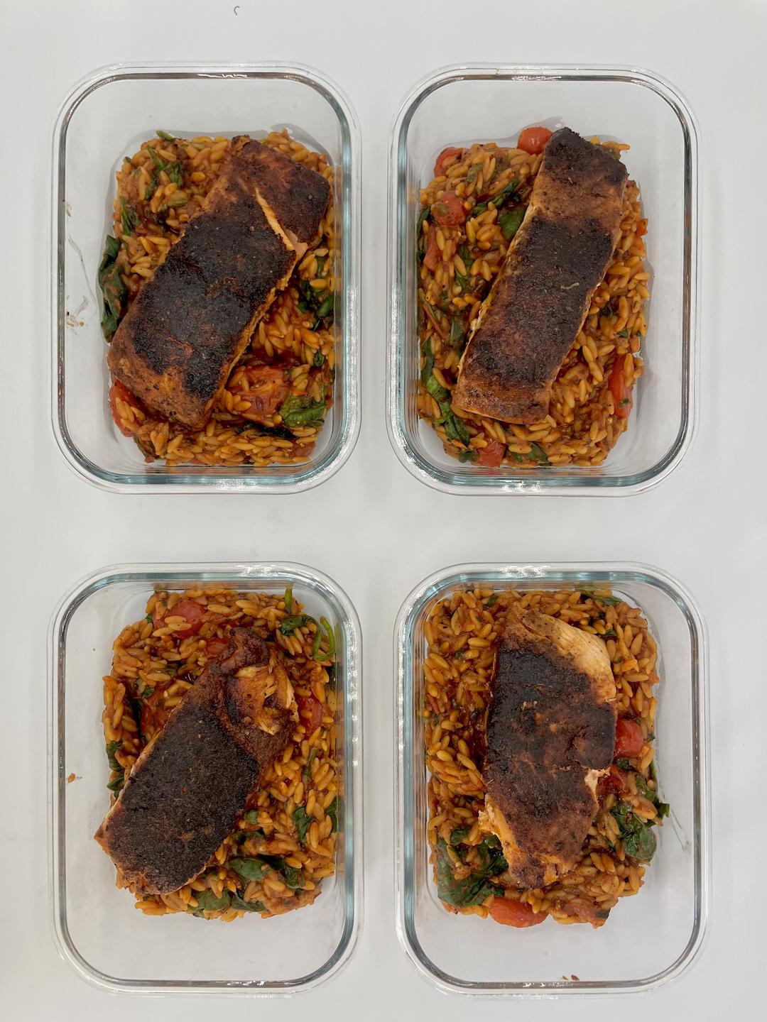 Four prepared servings of Spicy Tomato Basil Salmon Orzo