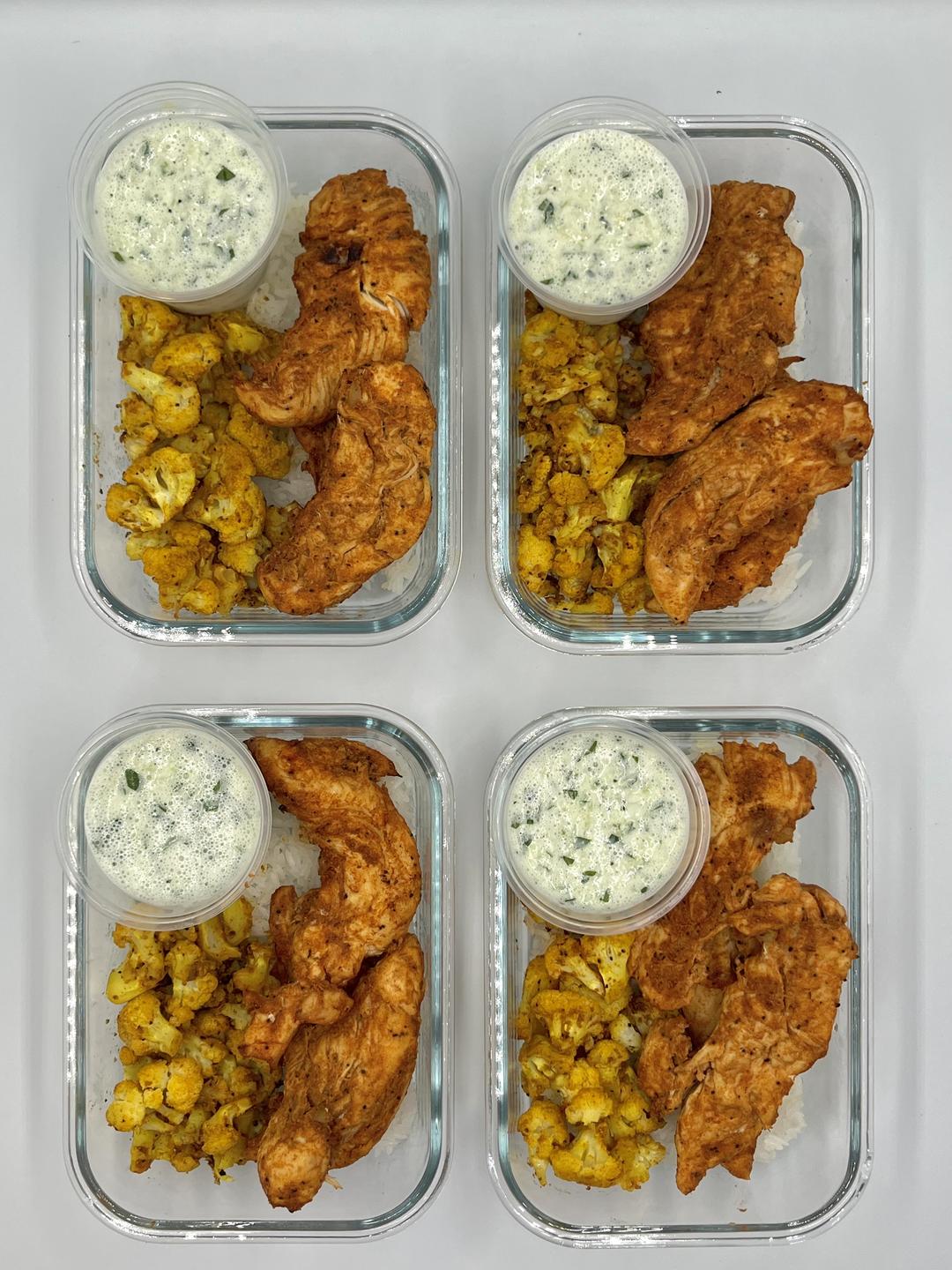 Four prepared servings of Tandoori Chicken Bowls
