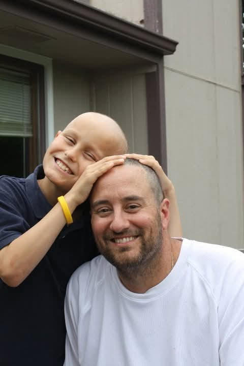 Bryan with his dad during childhood cancer treatment