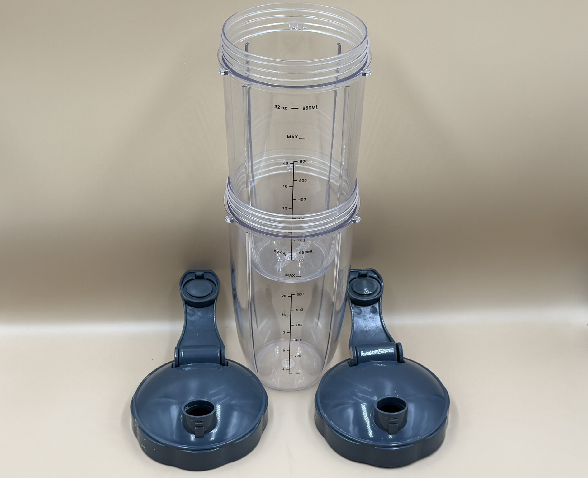 Multiple clear 32-ounce blender cups with lids