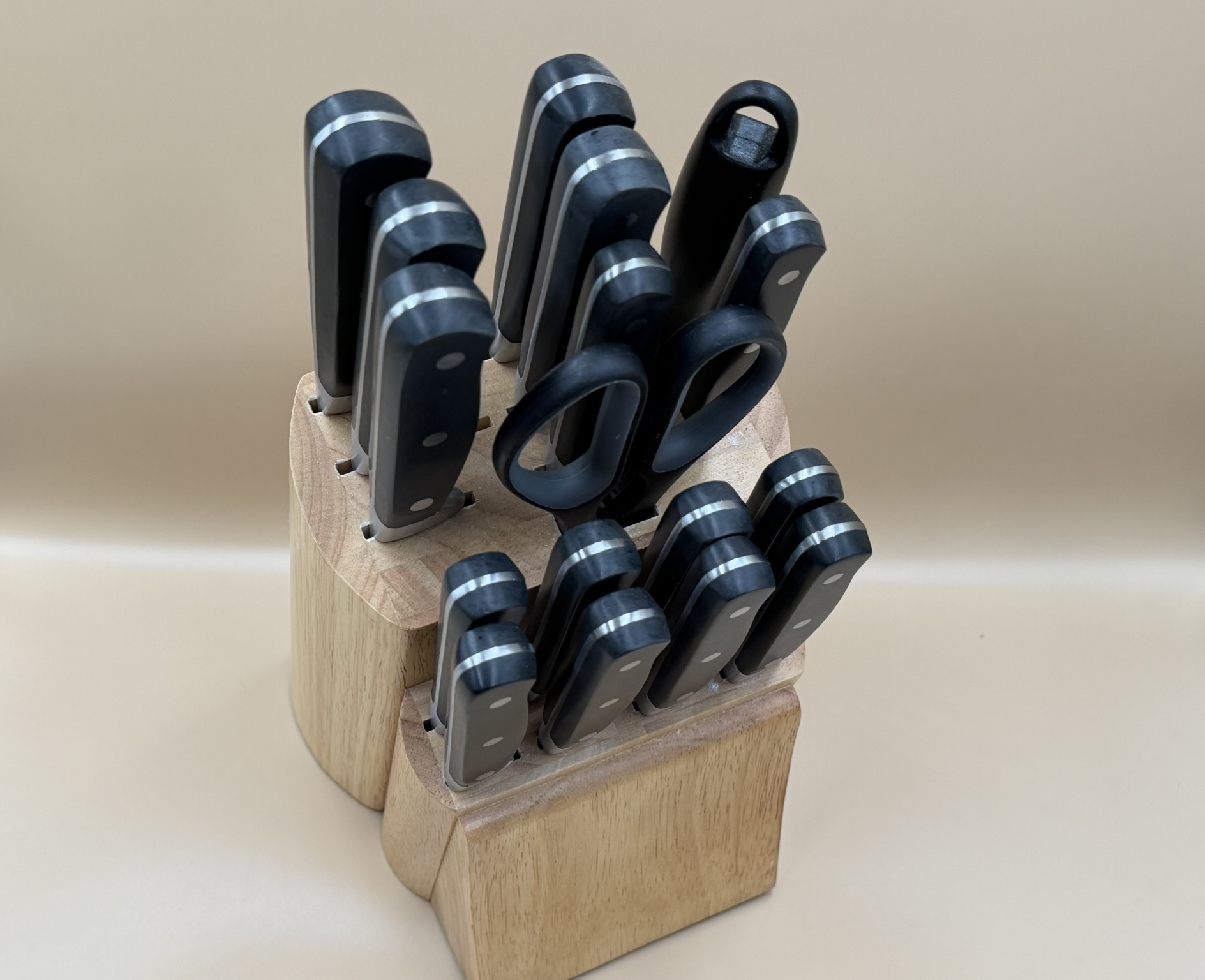 A wooden knife block holding a starter kitchen knife set